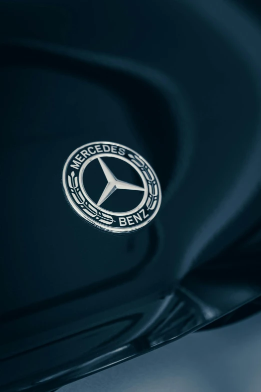 a mercedes emblem on the hood of a car, pexels contest winner, modernism, blue and black color scheme, profile image, embossed, enamel