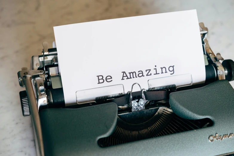 a close up of a typewriter with a paper on it, a picture, by Emma Andijewska, unsplash, bursting with positive energy, hopeful, in white lettering, amazing beauty