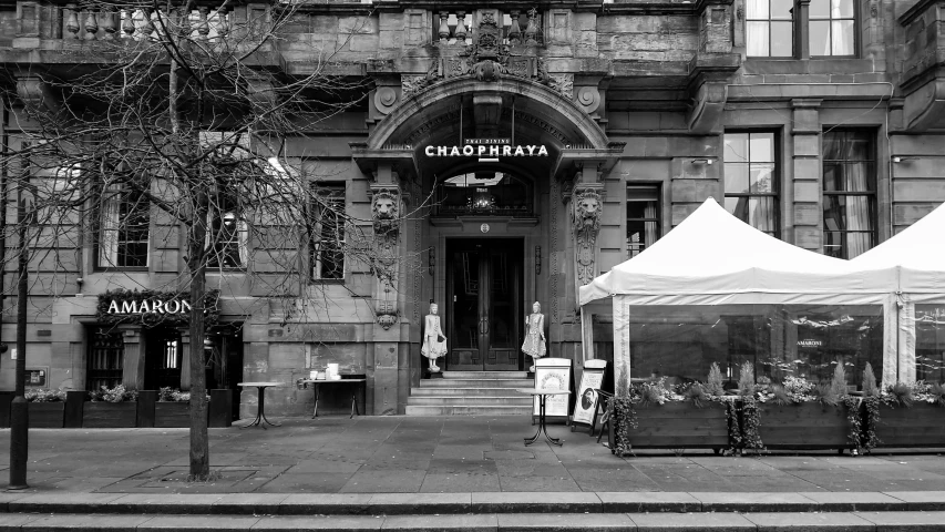 a black and white photo of a store front, by Emma Andijewska, art nouveau, glasgow, gazebos, portrait of gigachad, vendors