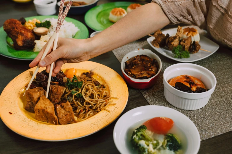 a person holding chopsticks over a plate of food, square, jakarta, fan favorite, image