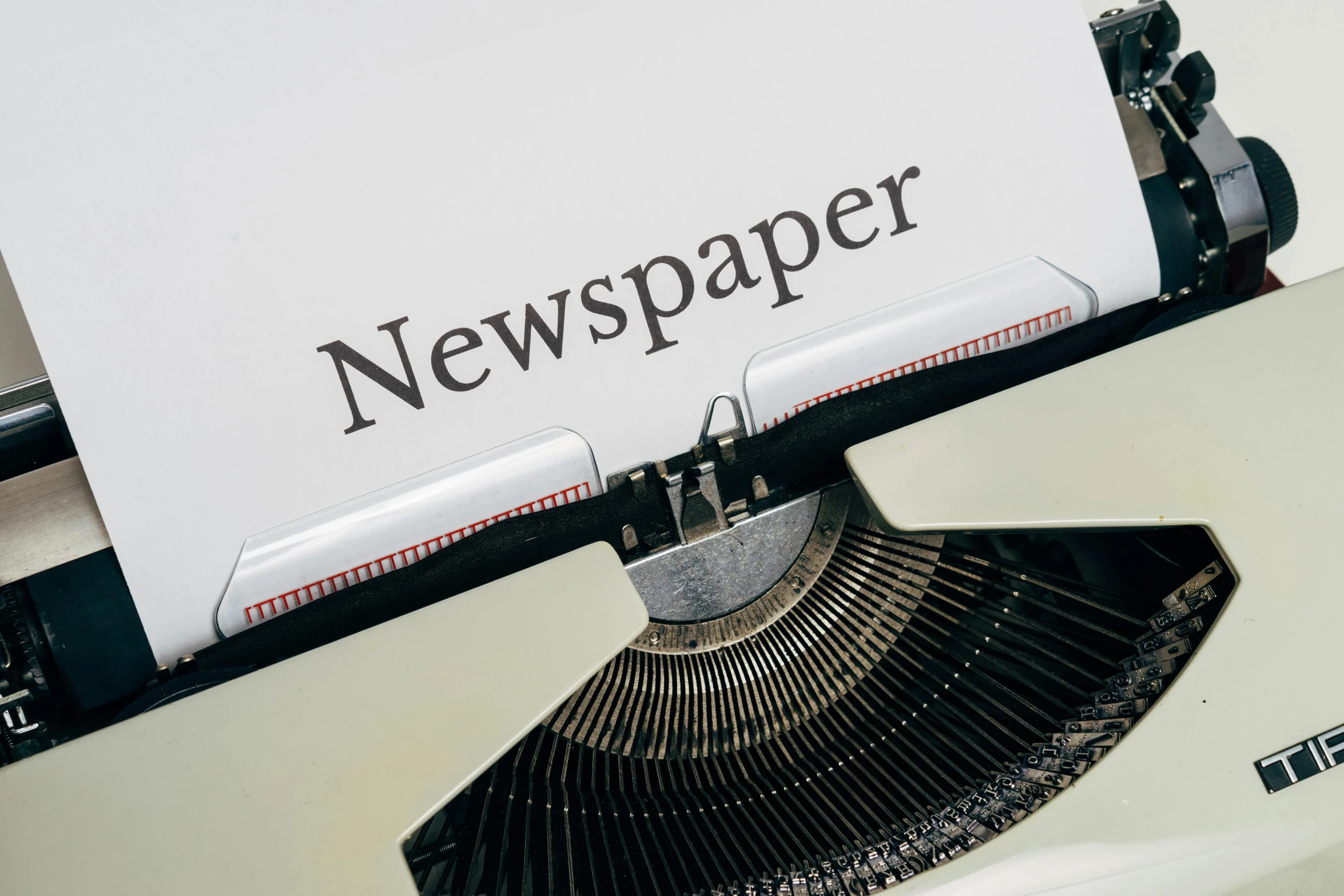 a close up of a typewriter with a newspaper on it, a picture, by John Murdoch, unsplash, private press, 15081959 21121991 01012000 4k, paper craft, thumbnail, celebration