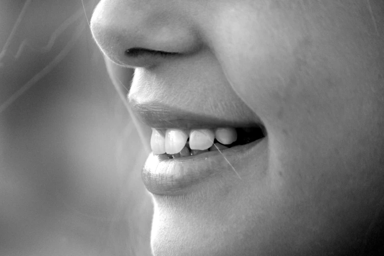 a black and white photo of a smiling girl, pixabay, tooth, close - up profile, square jaw-line, closeup detailed