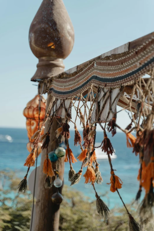 a close up of a pole near a body of water, decorations, overlooking the ocean, egyptian atmosphere, beachfront