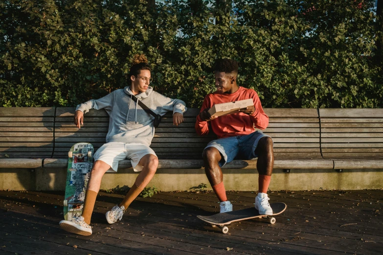 a couple of men sitting on top of a wooden bench, riding a skateboard, riyahd cassiem, wesley kimler, sports clothing