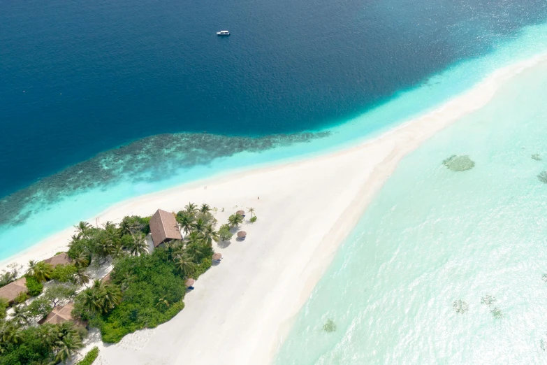 an aerial view of an island in the middle of the ocean, by Daren Bader, pexels contest winner, hurufiyya, white sand, luxurious environment, side, half and half