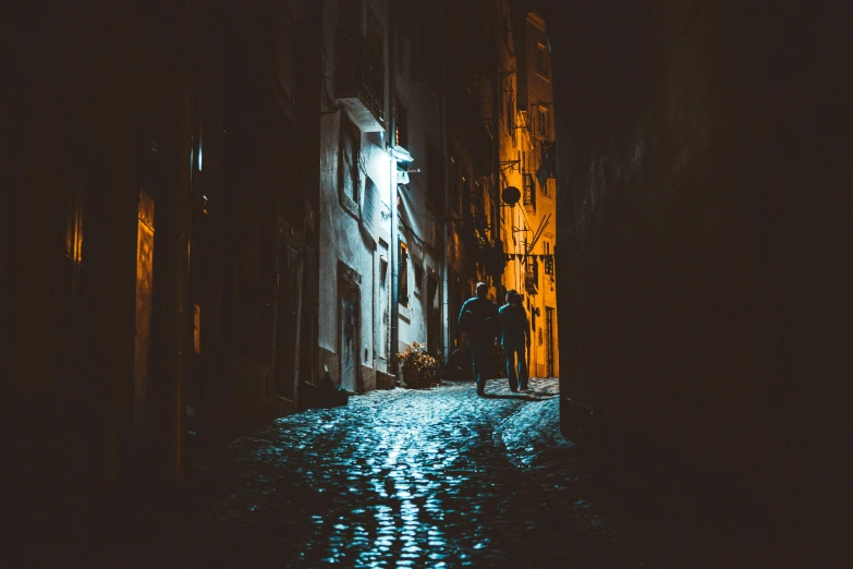 a person walking down a street at night, pexels contest winner, lisbon, halloween, shady alleys, profile image