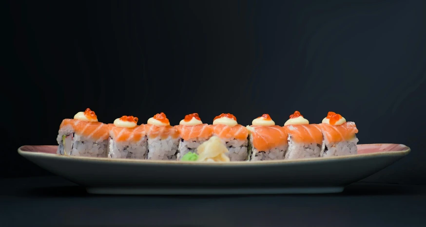 a plate of sushi on a black background, unsplash, white and orange, 3d with depth of field, sky line, left profile