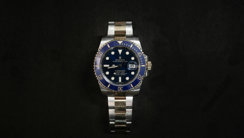 a rolex watch on a black background, a portrait, by Matthias Stom, deep blue sea color, thumbnail, 1/320, blue and white and gold