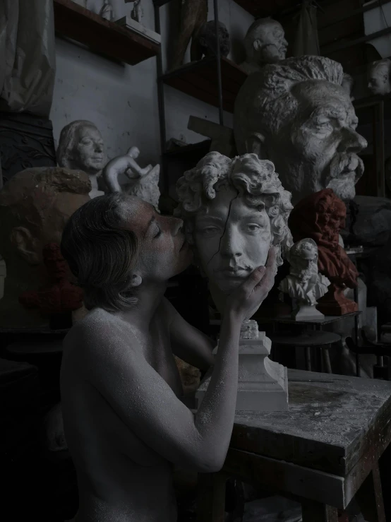 a woman sitting at a table with a statue in front of her, a marble sculpture, inspired by Alessandro Allori, unsplash contest winner, classical realism, making out, with several broken statues, in a workshop, face with artgram