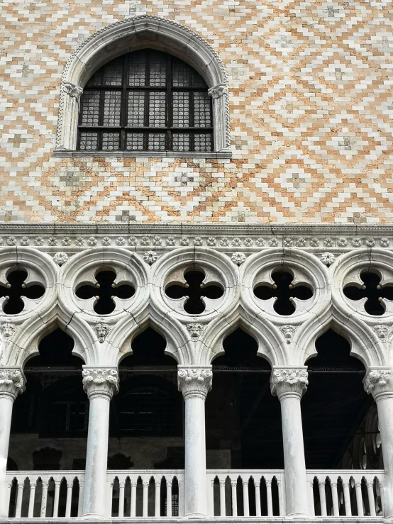 a clock that is on the side of a building, intricate venetian patterns, archways between stalagtites, looking towards the camera, thick squares and large arrows