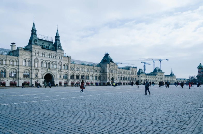 a group of people walking in front of a large building, by Julia Pishtar, pexels contest winner, socialist realism, kremlin, square, thumbnail, ground level view