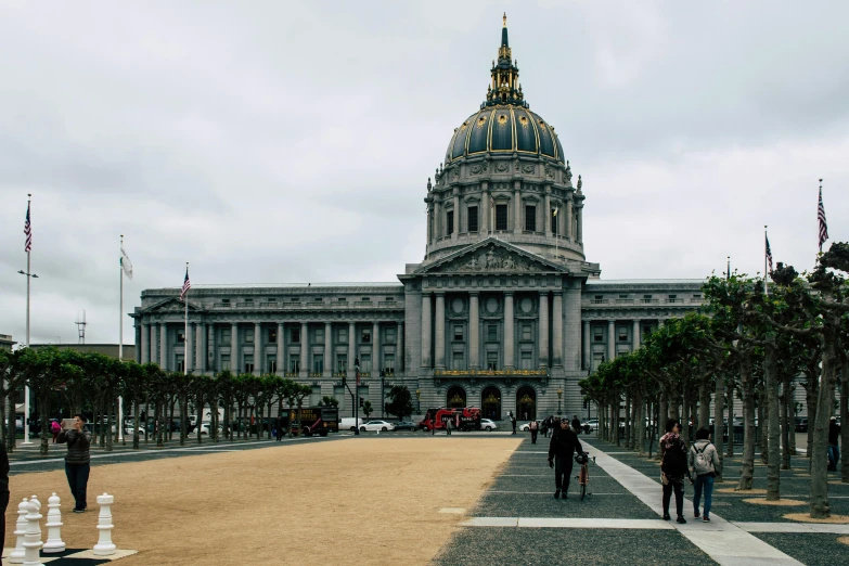 a group of people walking in front of a building, by Kristin Nelson, pexels contest winner, renaissance, sf, dome, background image, ground - level view