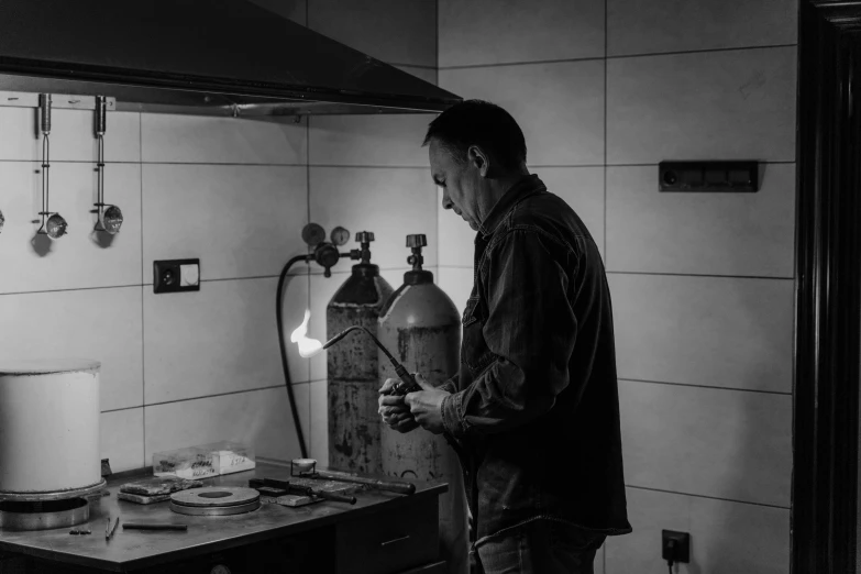 a black and white photo of a man in a kitchen, arbeitsrat für kunst, welding torches for arms, photo taken with nikon d 7 5 0, ceramic, today\'s featured photograph 4k