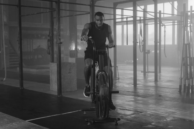 a man riding a bike in a gym, drake, uhq, epk, monochromatic