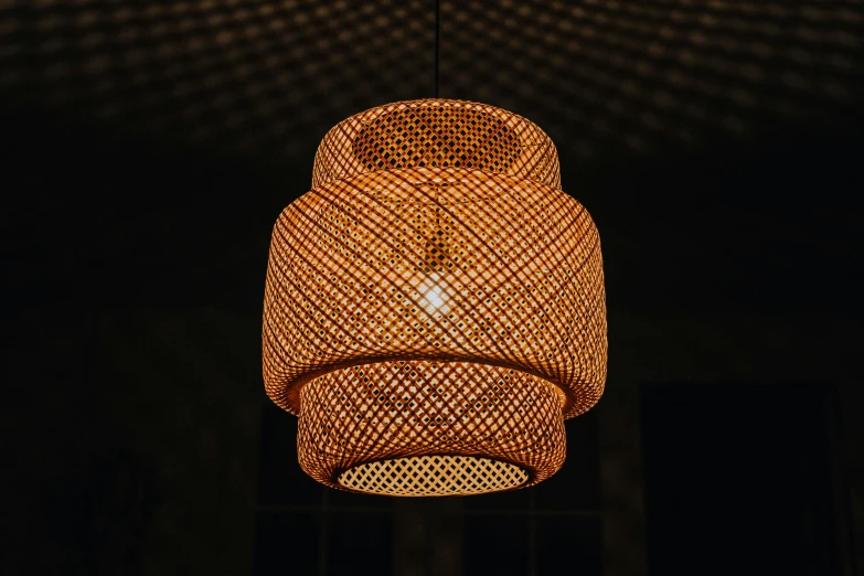 a close up of a light hanging from a ceiling, a portrait, inspired by Kanō Naizen, unsplash, made of bamboo, dim dusk lighting, detailed product shot, tiki