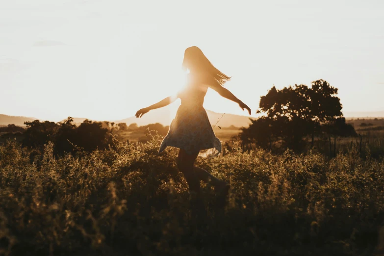 a woman standing in a field at sunset, pexels contest winner, happening, smiling and dancing, sunlit, girl running, transparent background