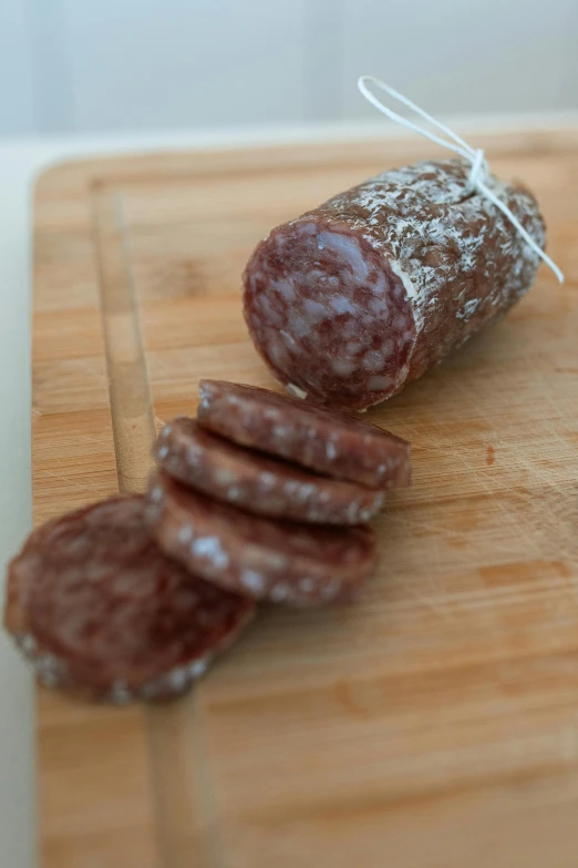 a close up of sliced sausage on a cutting board, by Emanuel Witz, chocolate, sparkling, tall, paisley