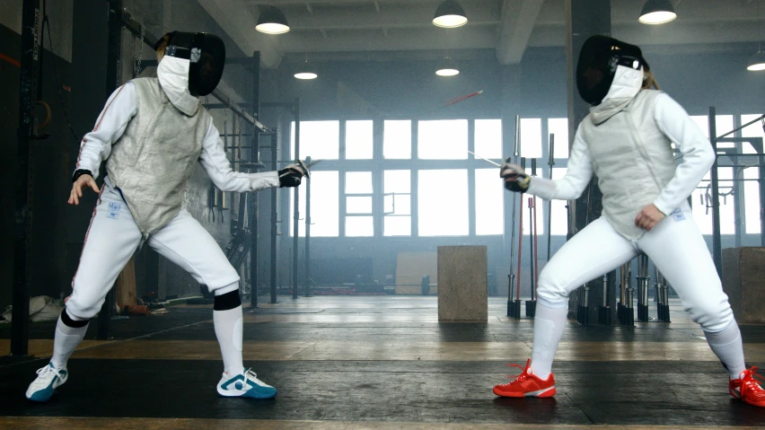 a couple of men standing next to each other on top of a wooden floor, fencing, reuters, hypebeast, ( ( theatrical ) )