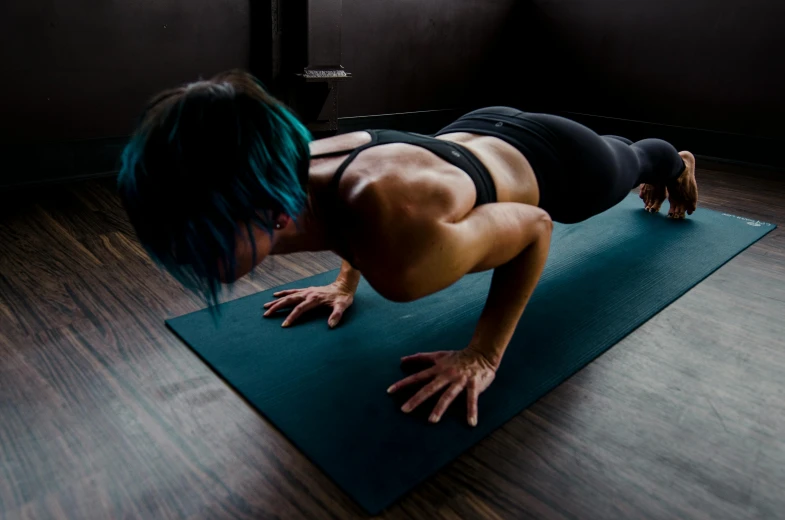 a woman doing push ups on a yoga mat, inspired by Elsa Bleda, pexels contest winner, private press, blue veins, australian, closed limbo room, profile image