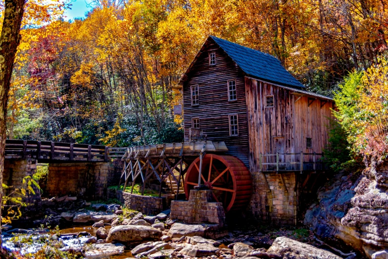 a wooden building with a water wheel in front of it, by Tom Carapic, pexels contest winner, looking over west virginia, 💋 💄 👠 👗, gold, professionally post - processed