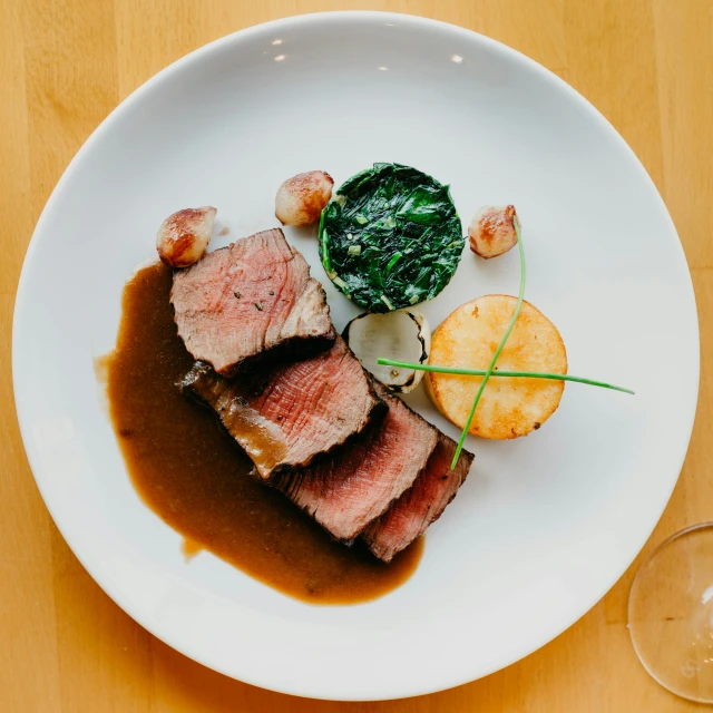 a white plate topped with meat and vegetables, by Carey Morris, pexels contest winner, john pawson, single body, goat, taiga