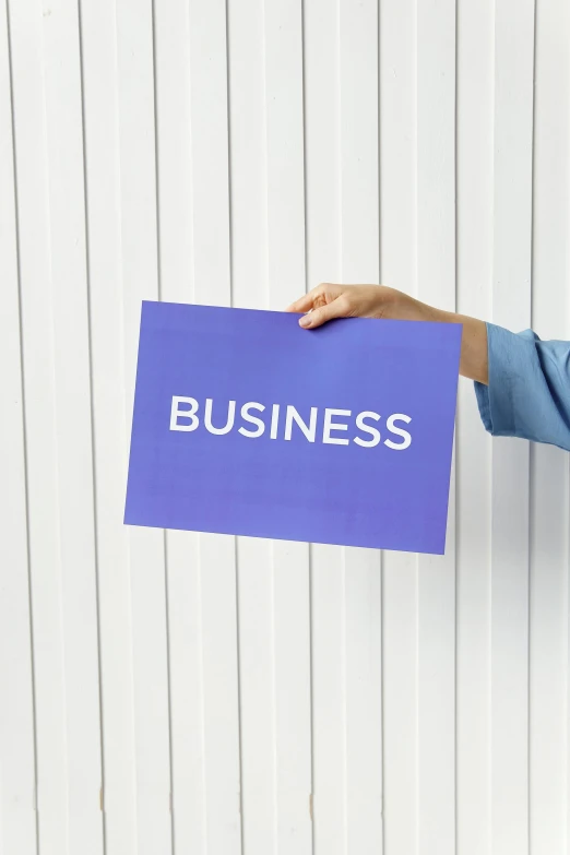 a woman holding a sign that says business, unsplash, private press, square, cut out of cardboard, background image, made of glazed