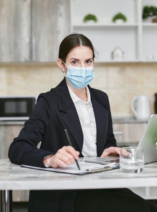 a woman sitting at a table with a laptop wearing a face mask, professional grade, thumbnail, medicine, girl in suit