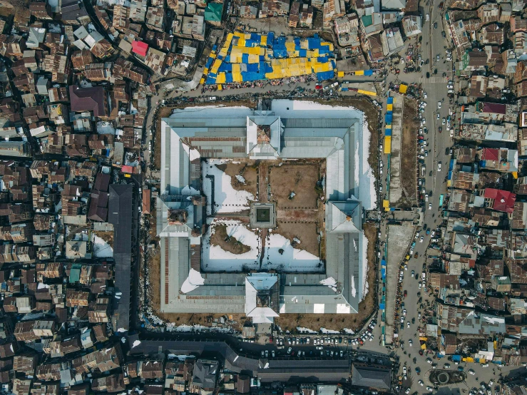 an aerial view of a city with lots of buildings, an album cover, by Ibrahim Kodra, unsplash contest winner, prison complex, square, aida muluneh, dezeen