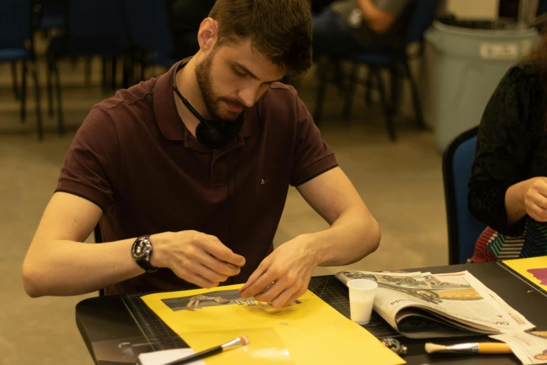 a man sitting at a table working on something, academic art, steam workshop, storyboarding, portait image