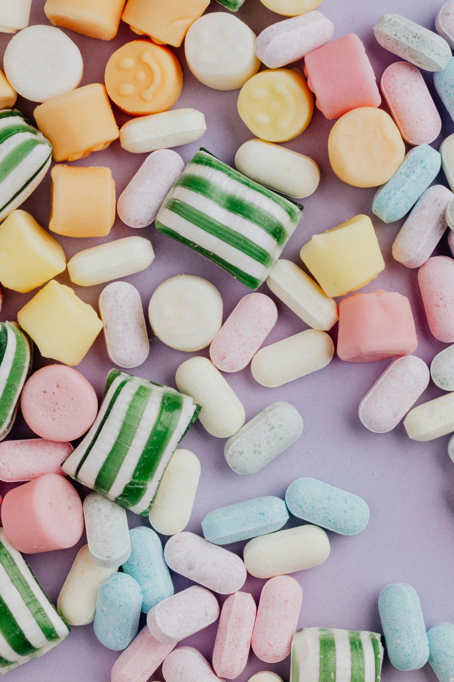 a bunch of candy sitting on top of a table, muted pastels, zoomed in, detailed product image, a medium shot