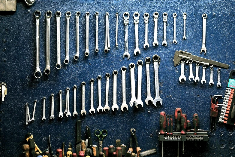 a bunch of tools that are on a wall, pexels contest winner, chrome motorcycle parts, blue - grey gear, engineering bay, rectangle