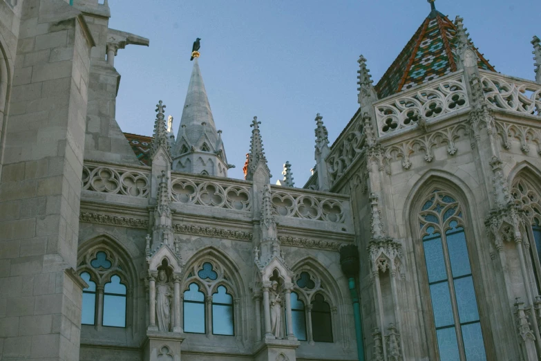 a very tall building with a clock on it's side, inspired by Mihály Munkácsy, pexels contest winner, art nouveau, tall stone spires, budapest, gothic library