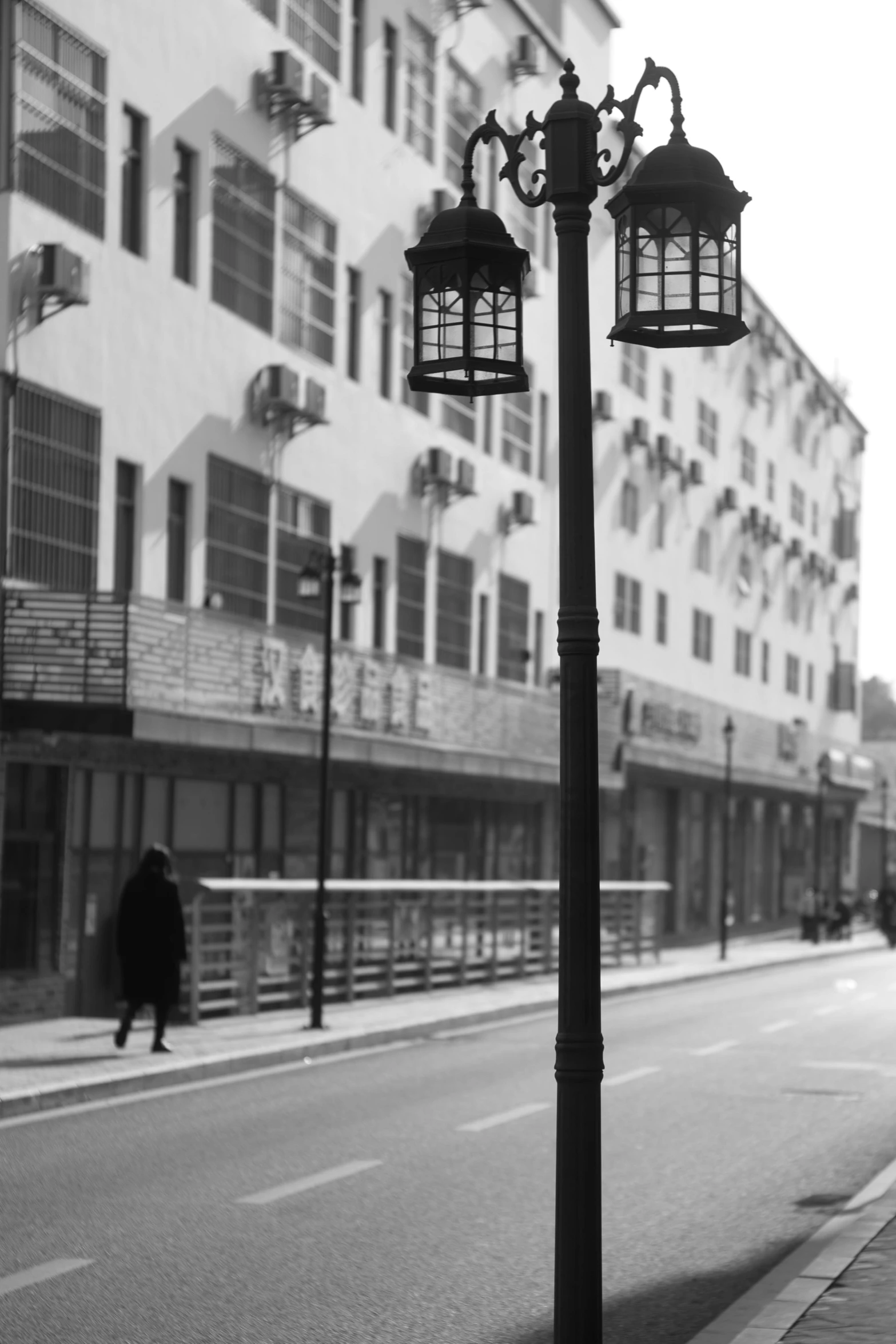 a black and white photo of a city street, arabesque, lamps, pensive lonely, slightly sunny weather, monochrome:-2