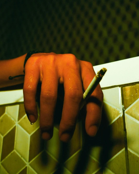 a person holding a cigarette in their hand, an album cover, inspired by Nan Goldin, unsplash, lgbt, marijuana ) wet, hotel room, high school