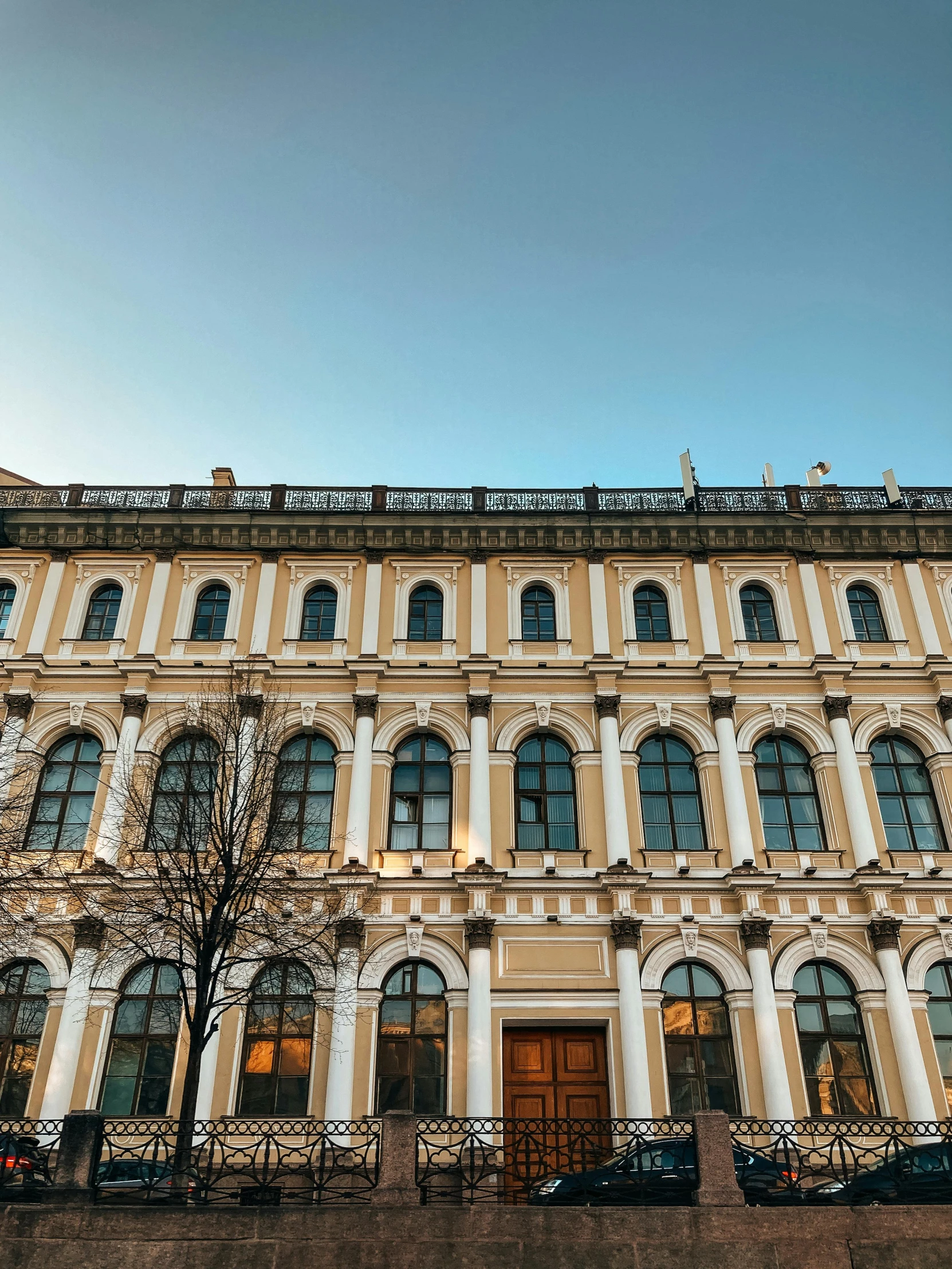 a large building with a clock on top of it, inspired by Mihály Munkácsy, pexels contest winner, neoclassicism, yellow windows and details, in moscow centre, thumbnail, a wide open courtyard in an epic