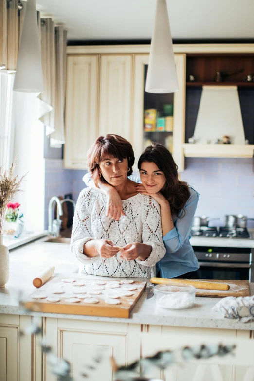 a couple of women standing next to each other in a kitchen, pexels contest winner, renaissance, ukrainian, family friendly, baking cookies, square