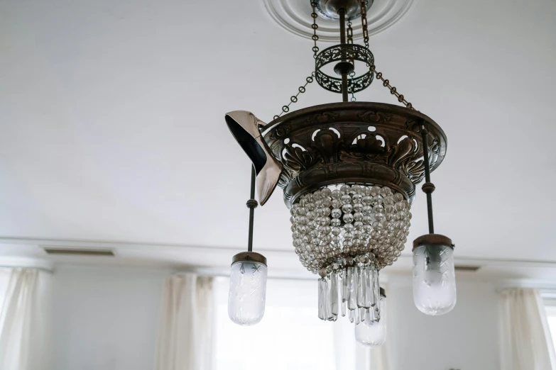 a chandelier hanging from the ceiling in a room, unsplash, fan favorite, well worn, with clear glass, sconces
