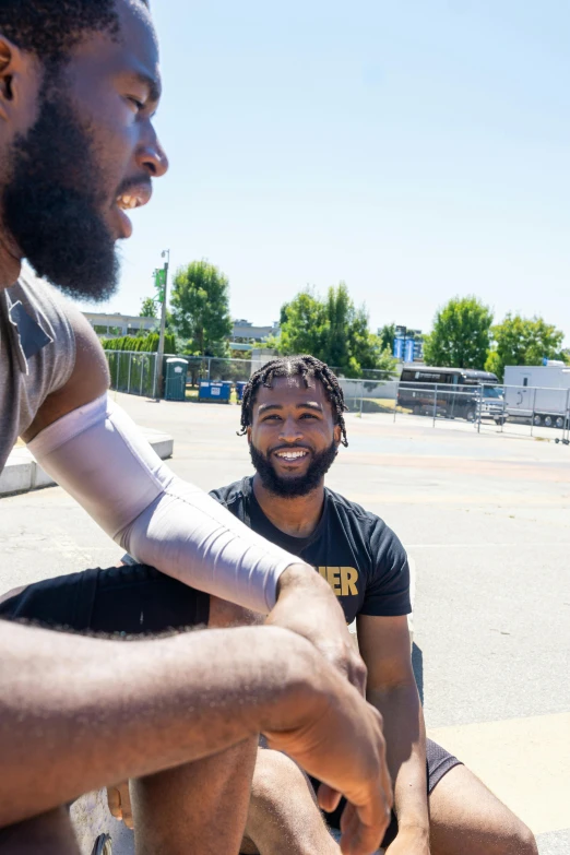 a couple of men sitting on top of a skateboard, by Washington Allston, featured on reddit, on a football field, aaron brooks, smiling at each other, seattle