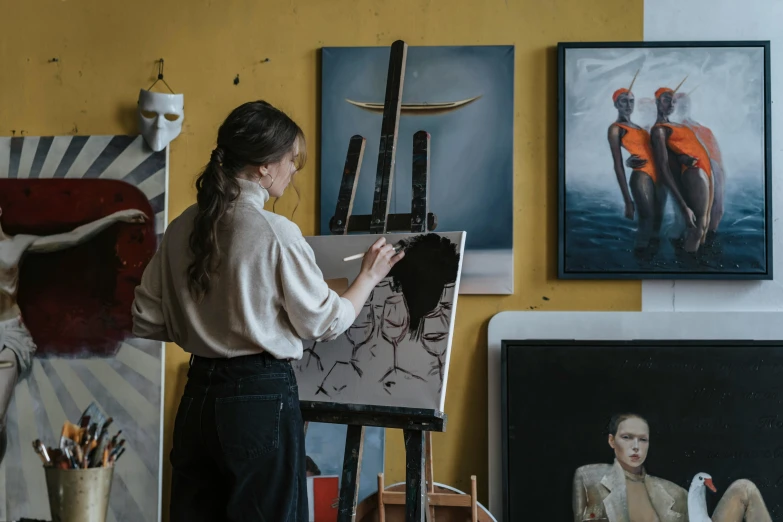 a woman that is standing in front of a painting, pexels contest winner, academic art, easel, various artworks, art workstation, on a yellow canva