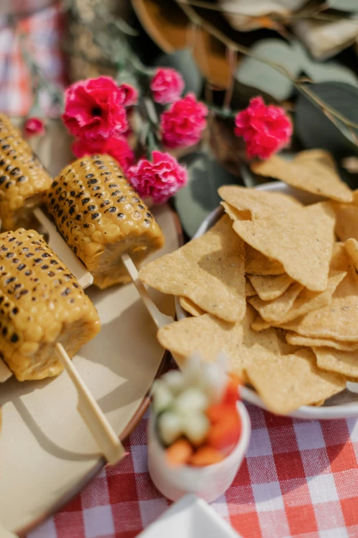 a close up of a plate of food on a table, having a picnic, condorito, parasols, gold flaked flowers