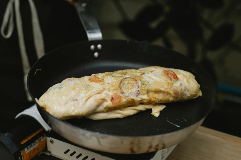 a pan filled with food sitting on top of a stove, fish made of pancake, longque chen, thumbnail, folded