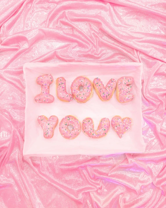 a white plate topped with donuts covered in sprinkles, an album cover, by Julia Pishtar, i love you, pastel pink neon, embroidered velvet, close-up photograph