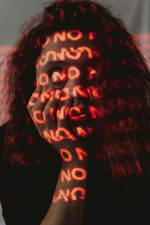 a woman covering her face with her hands, trending on pexels, ascii art, red neon details, a photo of a disheveled man, with haunted eyes and curly hair, (((((((no glow)))))))