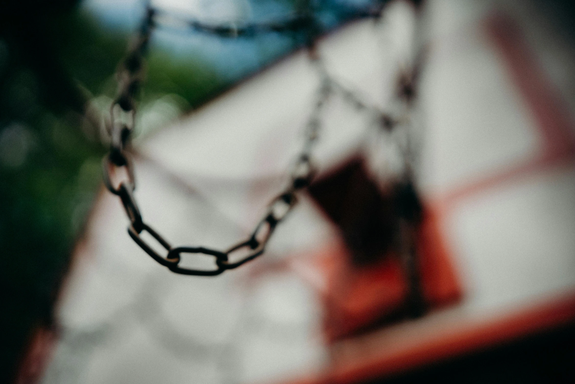 a chain hanging from the side of a basketball court, a tilt shift photo, trending on pexels, in an abandoned theme park, amanda lilleston, 15081959 21121991 01012000 4k, shot on hasselblad