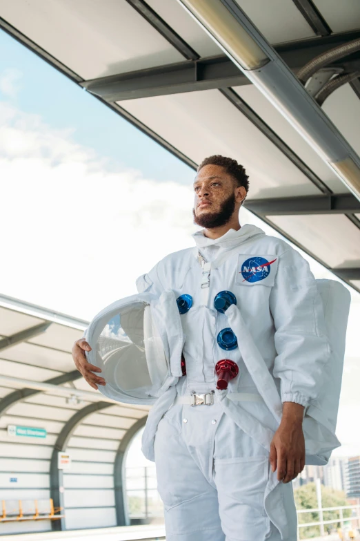 a man in a space suit posing for a picture, neymar jr, plain uniform sky, lewis jones, cosmoport