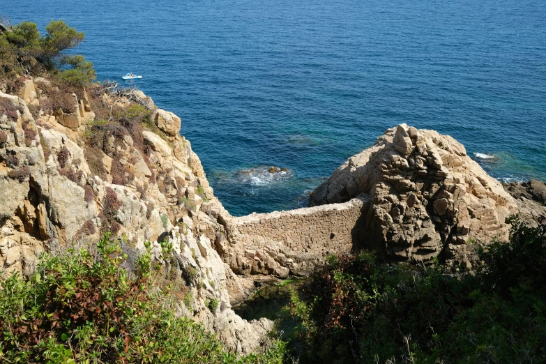 a view of the ocean from the top of a cliff, a picture, overgrown stone cave, múseca illil, stone walls, thumbnail