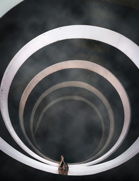 a man that is standing in the middle of a tunnel, inspired by Otto Piene, unsplash contest winner, kinetic art, planet with rings, standing in a stadium, ignant, concert photo