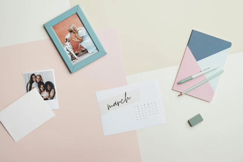 a photo frame sitting on top of a desk next to a calendar, a picture, pastel colour palette, cards, thumbnail