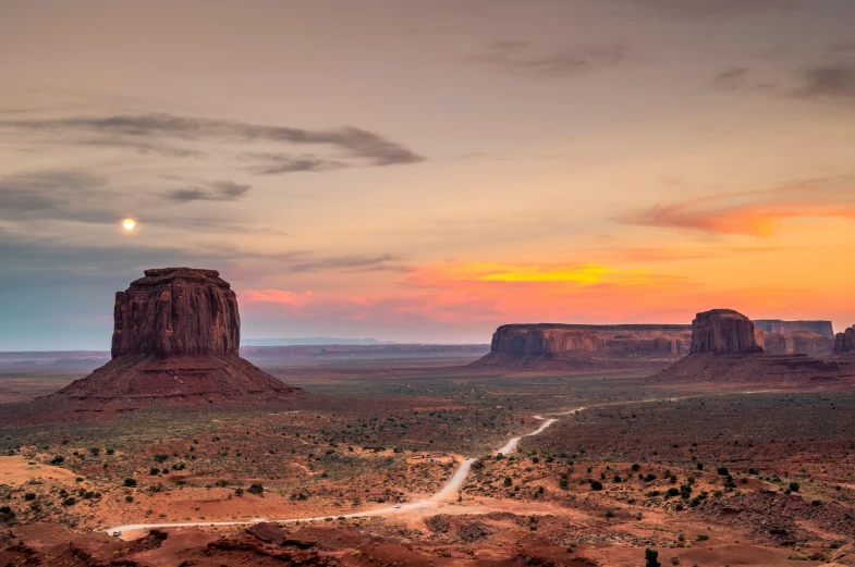 a desert landscape with a dirt road in the foreground, pexels contest winner, style of monument valley, cliff side at dusk, overlooking a valley with trees, slide show