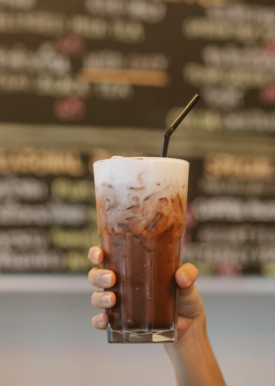 a close up of a person holding a drink, chocolate river, soft mist, thumbnail, cold brew coffee )